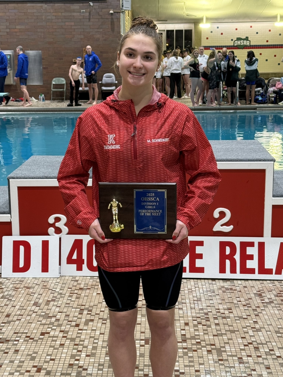 KHS Junior Maya Schweikert holding her division 1 female performer of the year plaque